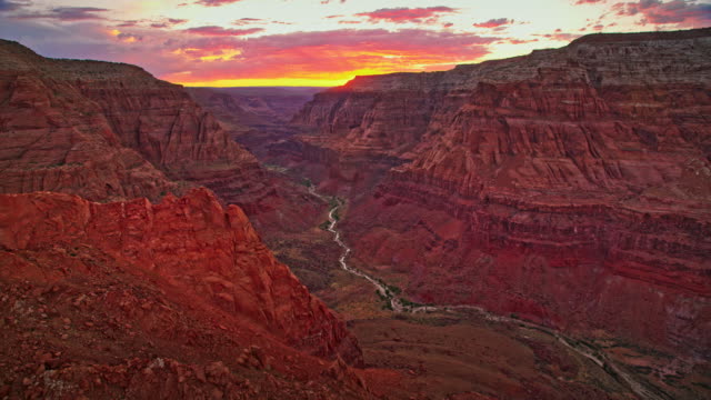 AERIAL Grand Canyon with setting sun in the background