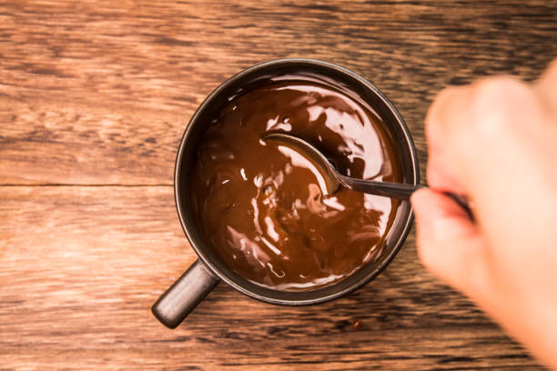 istock Mixing coffee with metal spoon 1185629269