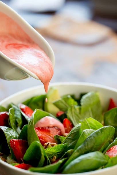 istock fresh salad with strawberries and sauce 1185629468