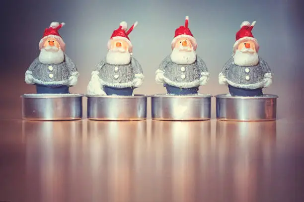 Group of candle lights in the form of little Santa Claus figures