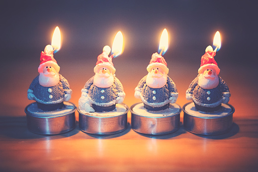 Group of candle lights in the form of little Santa Claus figures