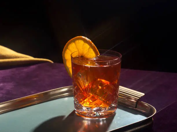 Negroni cocktail, with gin, bitter, vermouth, in pop contemporary style, colorful, dark background.