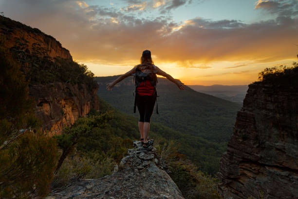 istock Hiker watches the sunset with mountain valley views 1185639981