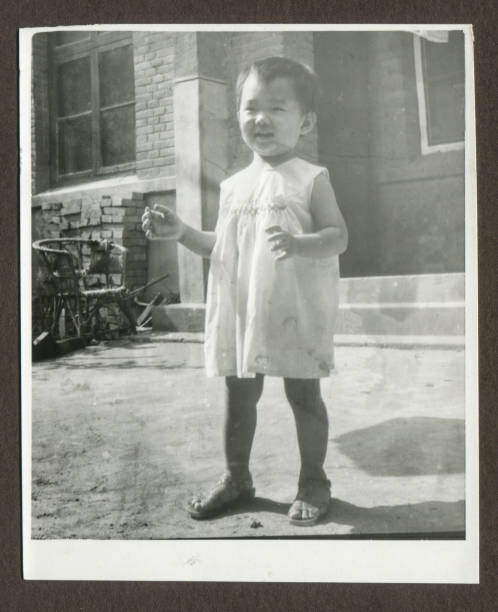 istock Cute little girl monochrome old photo 1185640113