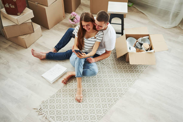 istock Top view. Cheerful young couple in their new apartment. Conception of moving 1185641349