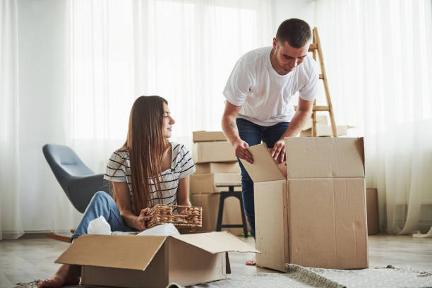 istock Time to unpack those boxes. Cheerful young couple in their new apartment. Conception of moving 1185641796