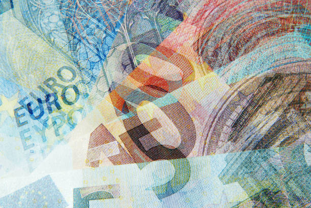 Close up of fifty-euro bills stacked on a table