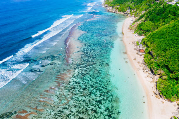 istock Bali, beach scene from above - blue ocean and rocky hills, covered with tropical trees. 1185643650