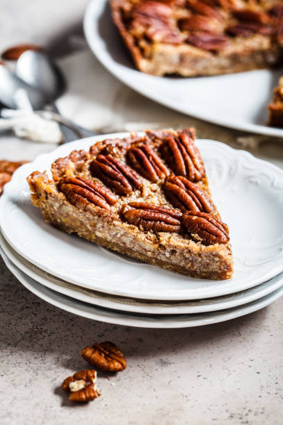 istock Piece of pecan Pie on gray-brown background. Vegan dessert concept. 1185644875
