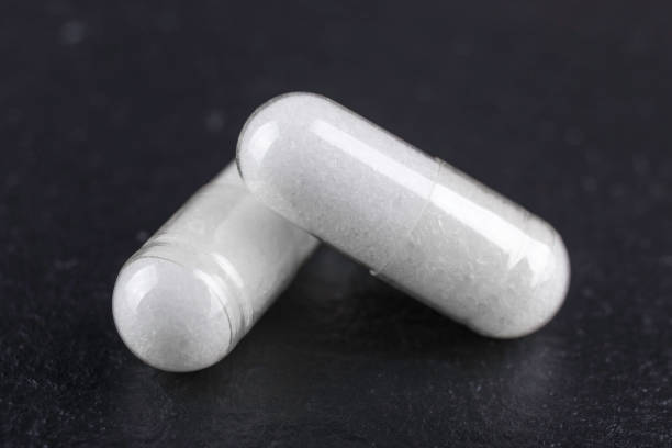istock two white capsules of nutritional supplement msm, sulfur on black background 1185645126