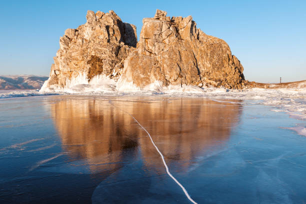 Winter Baikal. Olkhon Island. Reflection on the ice Shamanka rock stock photo
