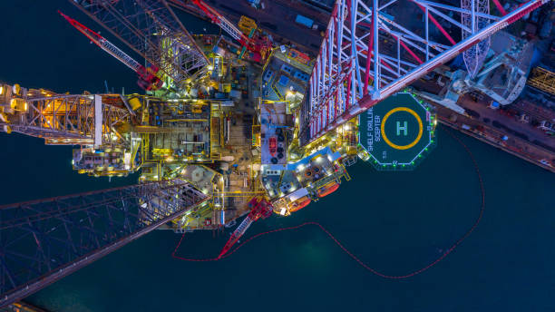 istock Aerial view offshore jack up rig  at night, Offshore oil rig drilling platform. 1185646658