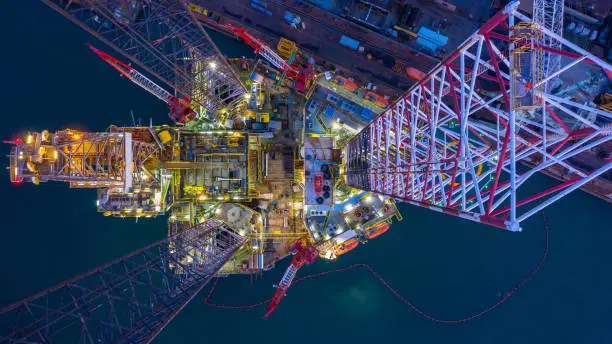 Photo of Aerial view offshore jack up rig  at night, Offshore oil rig drilling platform.
