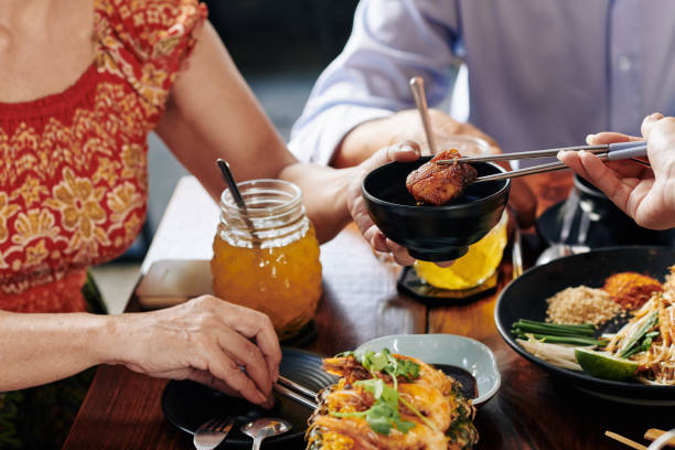 istock People eating Asian food at dinner 1185646754