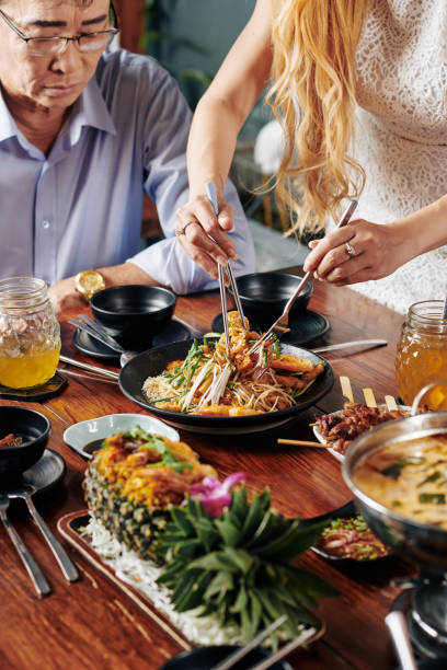 istock Housewife putting dish from bowl in plate 1185646783