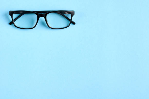 istock Black glasses on blue background composition, eyeglasses. 1185649000