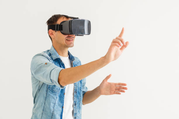 istock Man wearing virtual reality goggles. Studio shot, white background 1185650460