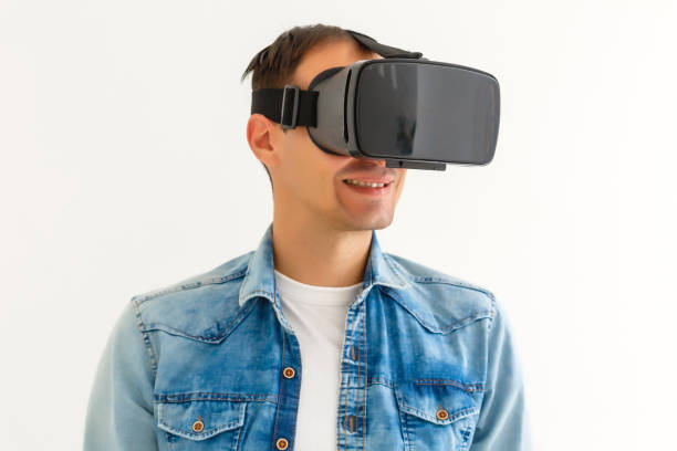 istock Man wearing virtual reality goggles. Studio shot, white background 1185650509