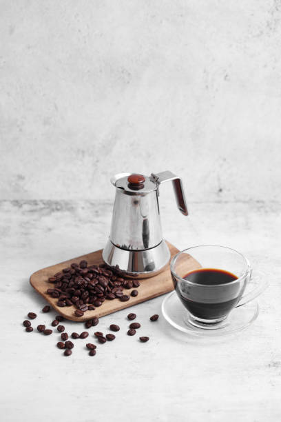 istock Coffee in cup and mocha pot on rustic table with a blank space for a text, Espresso in cup on white background 1185650896