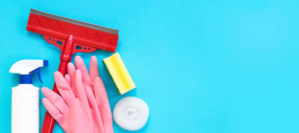 istock Cleaning and cleaning accessories, Gloves, spray, sponges, scraper for windows on a blue background. Cleaning Service Concept. Flat lay, Top view. 1185651009