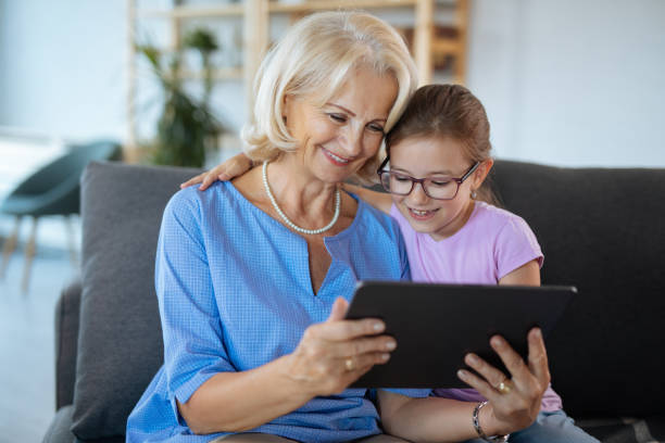 istock Grandma and granddaughter with digital tablet 1185651056