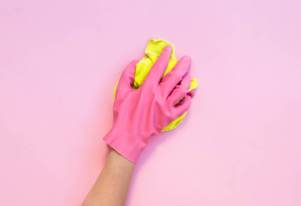 istock Woman's hand cleaning on a pink background. Cleaning or housekeeping concept background. Frame for text or advertising 1185652374