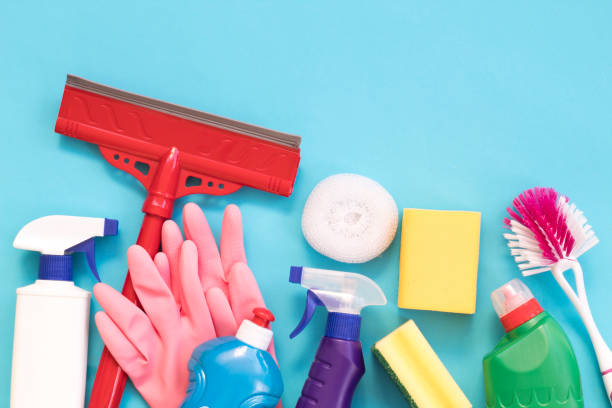 istock Cleaning and cleaning accessories, Gloves, spray, sponges, scraper for windows on a blue background. Cleaning Service Concept. Flat lay, Top view. 1185652662