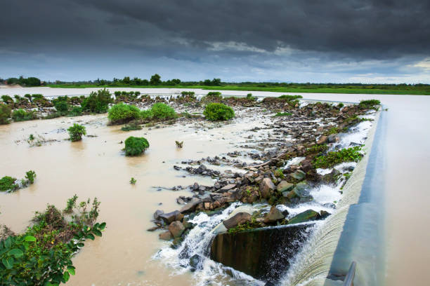 istock Tonle Sap River Dam spillway overflow on a rainy day. 1185655520