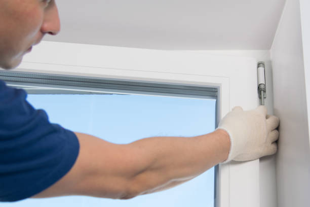 istock master in gloves, inserts the rod to fix the loop of the plastic window 1185655776