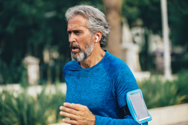istock Active senior man jogging on a sunny day 1185658847