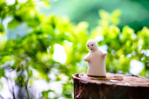 istock White ceramic doll Against the natural green background and bokeh 1185659750
