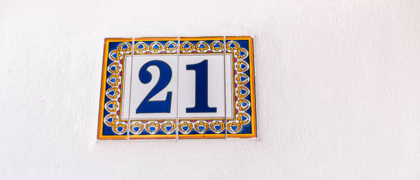 istock Decorative ceramic house number 21 tile on the wall, characteristic decorative element 1185660137
