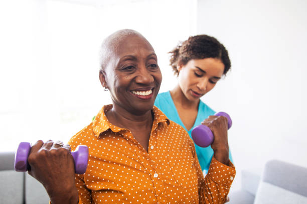 istock Physical Therapist With Her Patient at Home 1185660527