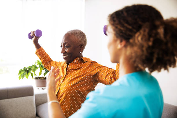istock Physical Therapist With Her Patient at Home 1185660529