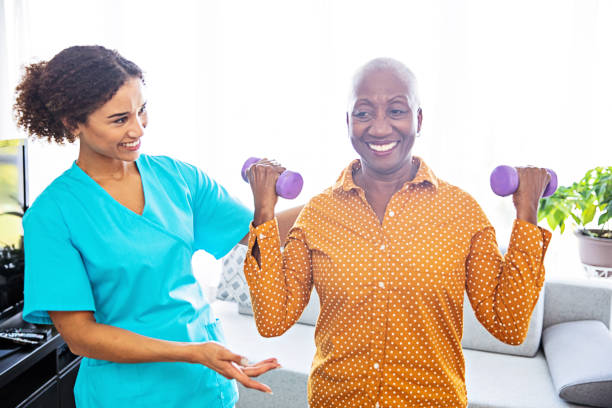 istock Physical Therapist With Her Patient at Home 1185660539