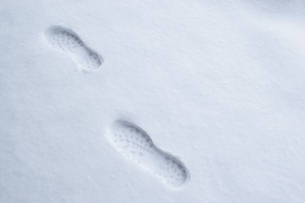 istock Human foot prints in the fresh snow 1185660624