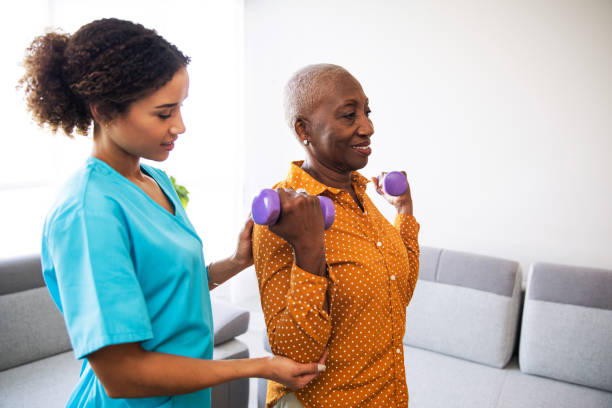istock Physical Therapist With Her Patient at Home 1185661196