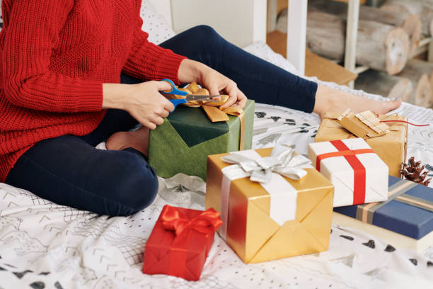 istock Woman wrapping gifts 1185663047