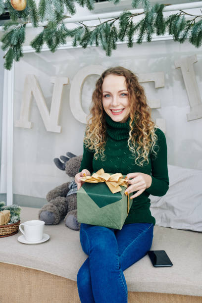 istock Pretty woman opening New Year gift 1185663163