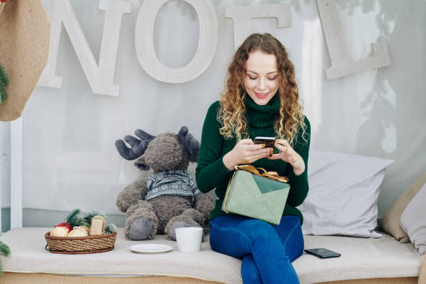istock Woman texting on Christmas eve 1185663172