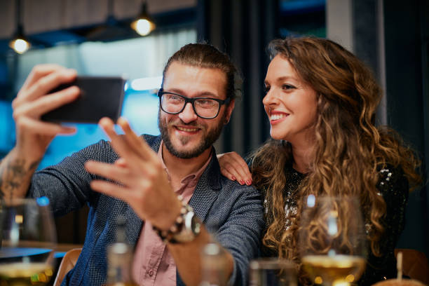 istock Couple taking selfie at restaurant. 1185664702