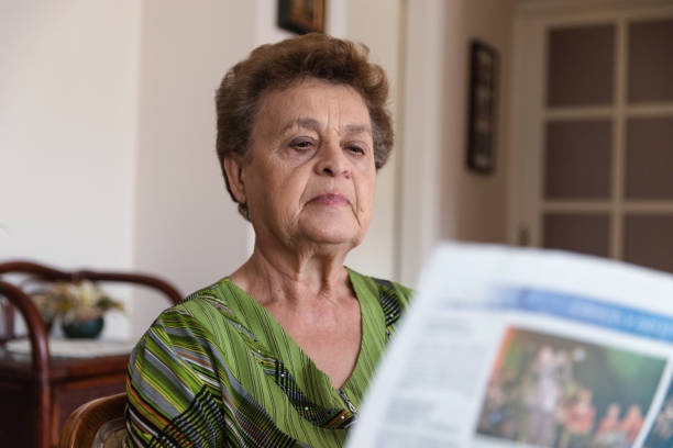 istock Old Lady with the Morning Newspaper 1185665311