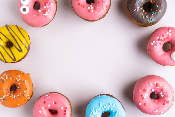 istock Set of various colorful donuts on white background. Top view. 1185665899