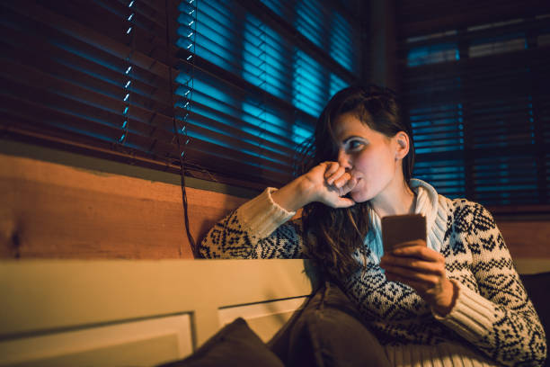 istock Beautiful woman using a mobile phone at night 1185666271