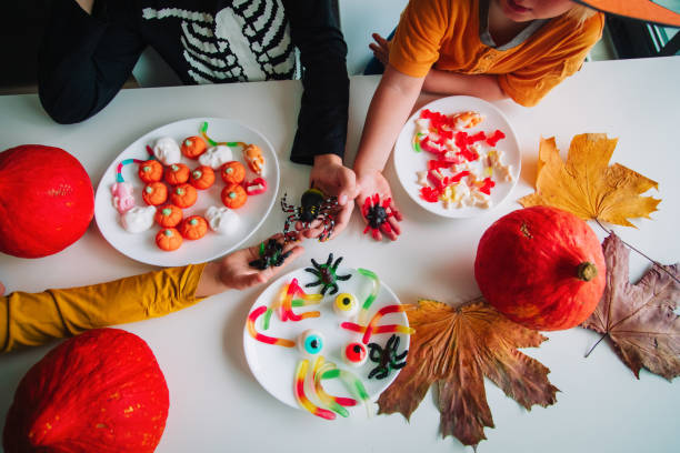 istock Halloween celebration. Kids sharing sweets, trick or treating 1185666586