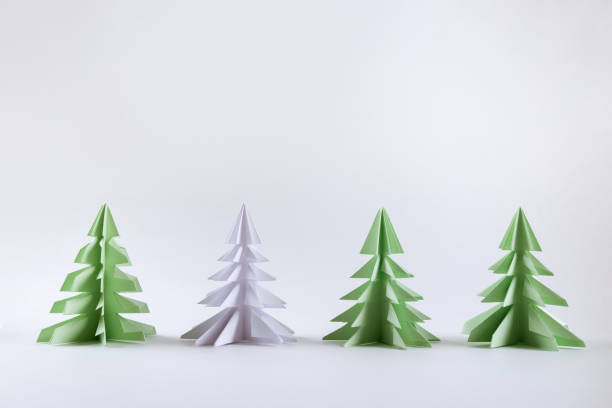 Christmas concept. Origami paper green Christmas trees. stock photo
