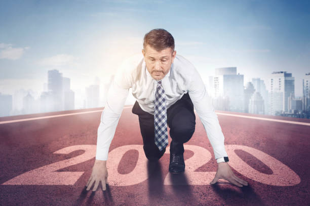 istock Caucasian businessman kneeling on numbers 2020 1185668327