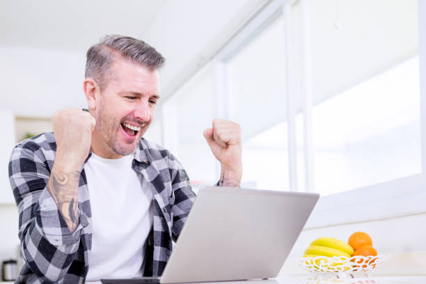 istock Caucasian man celebrating his success at home 1185668395