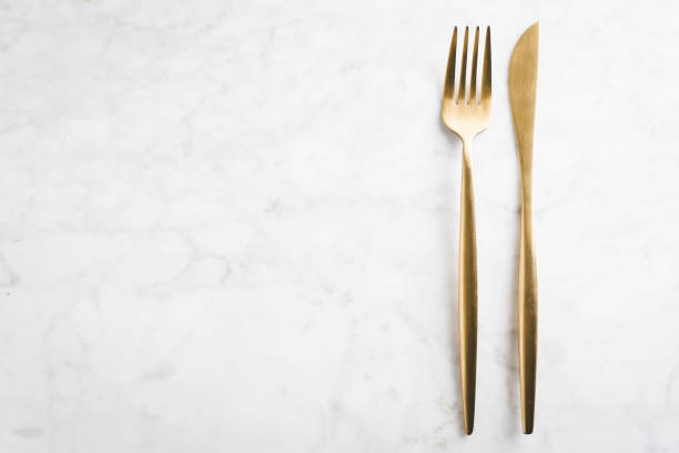 istock Gold cutlery set on marble background 1185670899