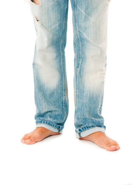 istock Barefoot man in jeans trousers on white background 1185673814
